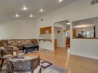 Step into this inviting living space, featuring a comfortable sectional sofa and stylish accent chairs.