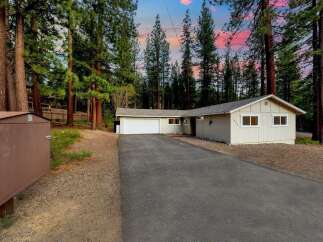 Nestled amidst towering trees, this charming property offers a serene escape.