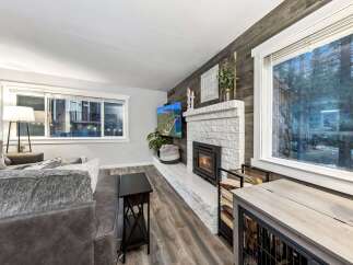 Step into this inviting living space, featuring a cozy fireplace and ample natural light.