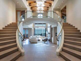 Step into luxury with this stunning property featuring a grand staircase and breathtaking views.