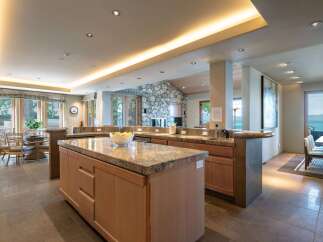 This stunning kitchen boasts a spacious island with granite countertops, perfect for meal preparation and entertaining.