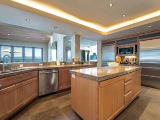 This stunning kitchen boasts a modern design with high-end appliances and ample counter space, perfect for culinary enthusiasts.