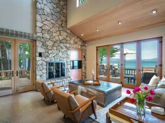 This stunning living room boasts a striking stone fireplace, creating a cozy ambiance.