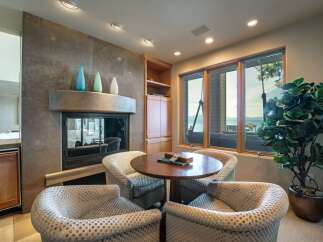 This stunning living space features a cozy seating area with a fireplace, perfect for relaxing evenings.