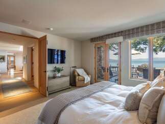 Experience luxury living in this stunning bedroom with breathtaking lake views.