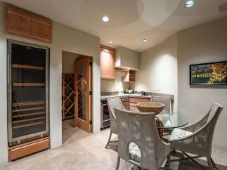 Step into luxury with this stunning wine cellar and tasting area.