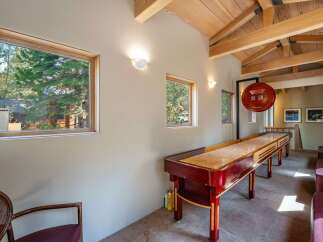 This stunning property boasts a game room with a shuffleboard table, perfect for entertaining guests.