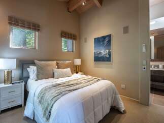 This stunning bedroom offers a serene retreat with its neutral color palette and natural light.