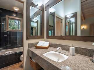 This luxurious bathroom features a stunning granite countertop, offering both elegance and durability.