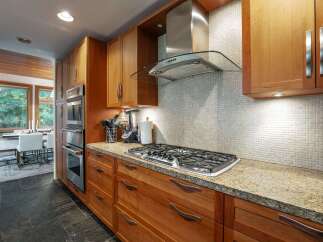 This stunning kitchen boasts custom cabinetry, granite countertops, and high-end stainless steel appliances.