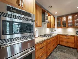 This stunning kitchen boasts modern appliances and elegant cabinetry, perfect for culinary enthusiasts.