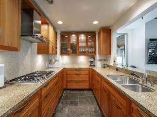 This stunning kitchen boasts custom cabinetry, granite countertops, and high-end appliances.