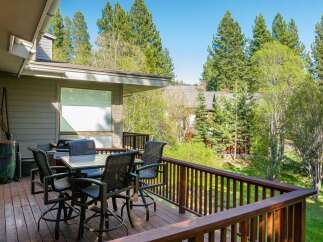 Enjoy the tranquility of this stunning property with a spacious deck, perfect for outdoor dining and relaxation.