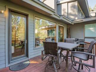 Enjoy outdoor living at its finest with this stunning property featuring a spacious deck and a cozy dining area.