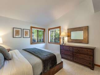 This inviting bedroom features a cozy bed with plush bedding, perfect for a relaxing retreat.