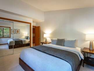This inviting bedroom boasts a comfortable bed with plush bedding and stylish accent pillows.