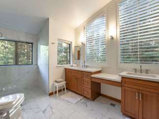 This luxurious bathroom boasts a modern design with elegant marble flooring and a spacious walk-in shower.