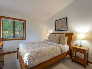 Experience tranquility in this inviting bedroom, featuring a cozy bed and a serene ambiance.