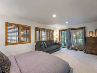 This stunning bedroom boasts a serene ambiance with its natural light and elegant design.