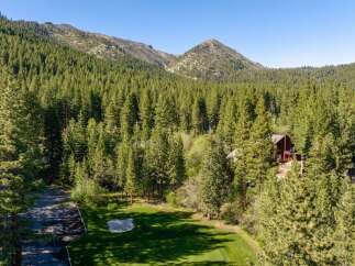 Nestled amidst a lush, green landscape, this stunning property offers a serene escape.