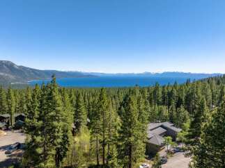 Experience breathtaking views from this stunning property nestled in a serene, forested setting.