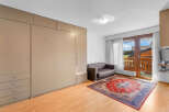 Discover this charming property featuring a cozy living space with a comfortable sofa and a vibrant rug.