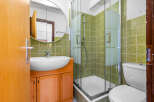 This bathroom features a modern design with a sleek sink and a spacious shower.