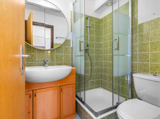This bathroom features a modern design with a sleek sink and a spacious shower.