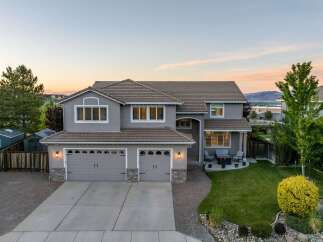 This stunning two-story home boasts a beautiful exterior with a well-manicured lawn and inviting curb appeal.