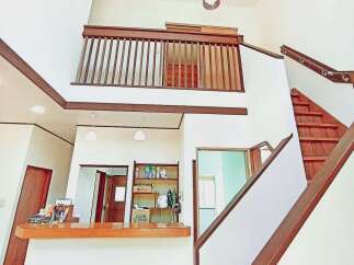 This stunning property boasts a unique architectural design with a spacious interior and high ceilings.