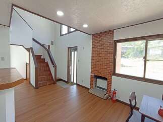 Discover this charming property featuring a cozy living space with a brick fireplace, perfect for relaxing evenings.