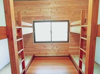 Step into this cozy bunk room, perfect for a vacation home or a kid's room.