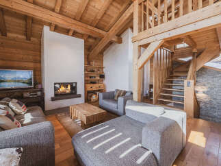 Experience rustic charm and modern comfort in this stunning mountain chalet living room.