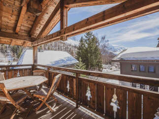 Enjoy breathtaking mountain views from this charming wooden balcony, perfect for morning coffee or evening relaxation.
