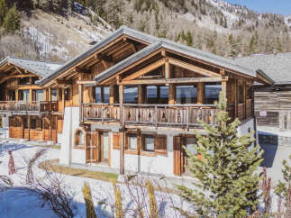 Experience the charm of alpine living in this stunning wooden chalet, nestled amidst snow-dusted mountains.