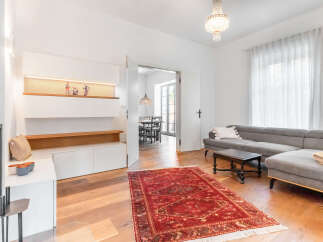 Step into this beautifully appointed living space, featuring a plush grey sectional sofa perfect for relaxation and entertaining.