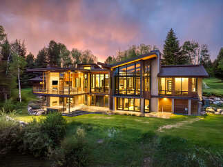 Experience luxury living in this stunning modern home, featuring expansive floor-to-ceiling windows that flood the interior with natural light and offer breathtaking views.