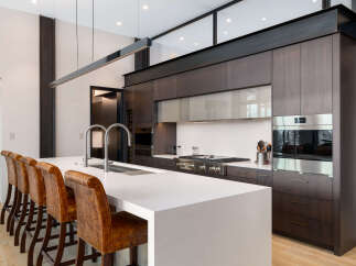 Experience luxury living in this modern kitchen featuring a spacious island with bar seating, perfect for entertaining.