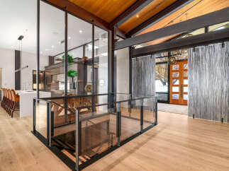 Experience modern luxury in this stunning home featuring an open-concept living space with a sleek kitchen and elegant dining area.
