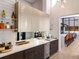 Experience modern luxury in this stunning kitchen featuring sleek, high-gloss cabinetry and a pristine white countertop.
