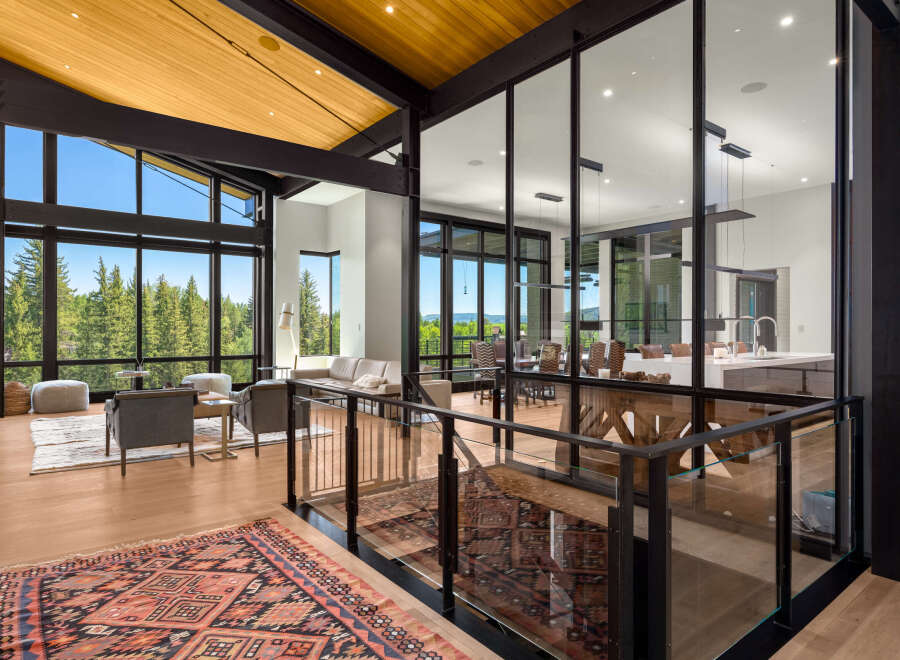 Experience luxurious modern living with this stunning open-concept home, featuring soaring ceilings and expansive windows that flood the space with natural light.