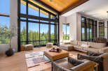 Experience luxury living with this stunning modern home featuring expansive floor-to-ceiling windows that showcase breathtaking forest and mountain views.