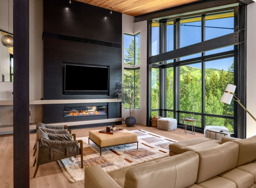 Experience luxury living in this stunning modern living room, featuring a sleek fireplace and a large television for entertainment.