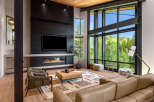 Experience luxury living in this stunning modern living room, featuring a sleek fireplace and a large television for entertainment.