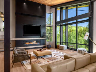 Experience luxury living in this stunning modern living room, featuring a sleek fireplace and a large television for entertainment.