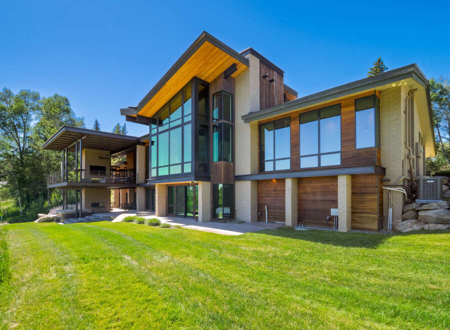 Experience modern luxury in this stunning architectural home, featuring expansive floor-to-ceiling windows that flood the interior with natural light and offer breathtaking views.