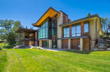 Experience modern luxury in this stunning architectural home, featuring expansive floor-to-ceiling windows that flood the interior with natural light and offer breathtaking views.