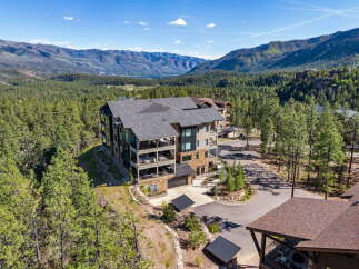 Experience luxury mountain living in this stunning property, nestled amidst a serene forest with breathtaking panoramic views of the surrounding peaks.