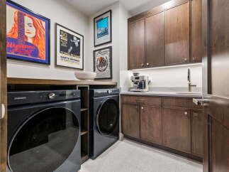 Experience ultimate convenience in this modern laundry room, featuring a stacked Samsung washer and dryer set.
