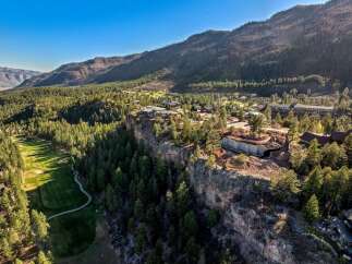 Experience unparalleled luxury with this stunning cliffside estate, offering breathtaking panoramic views of the surrounding mountains and lush pine forests.